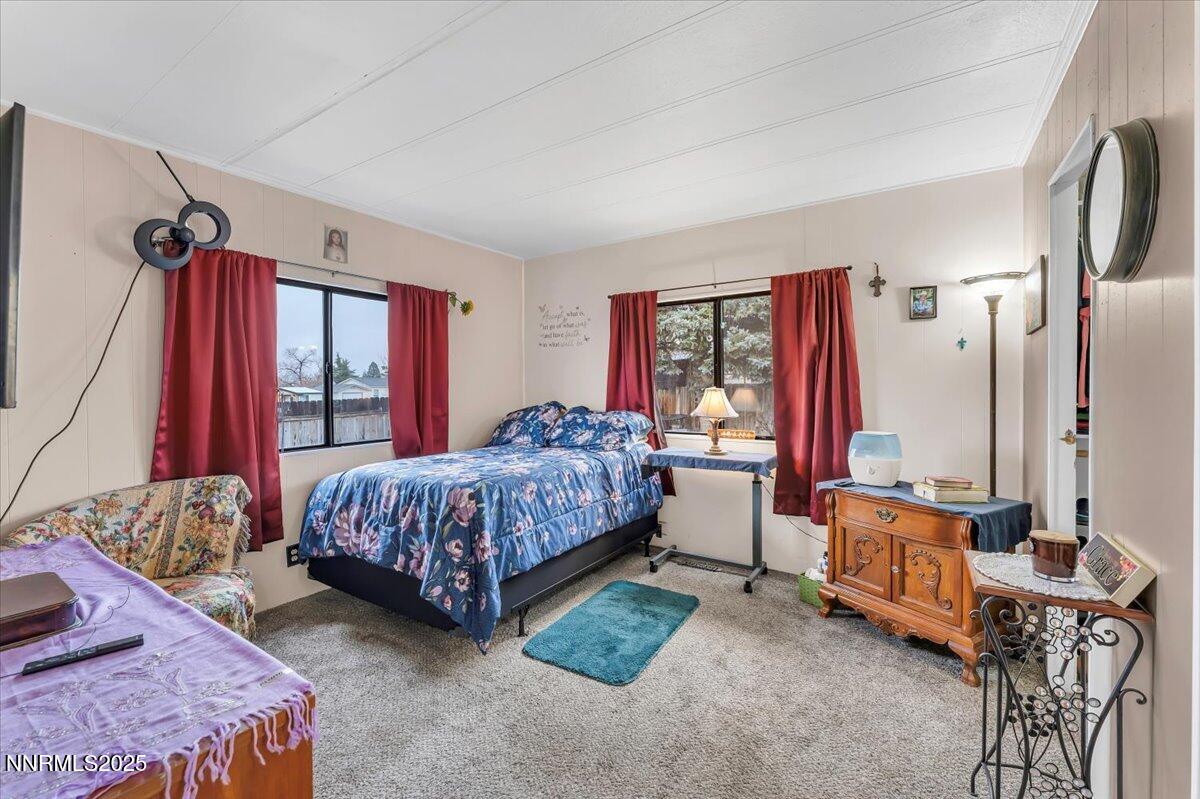 485 Capricorn Circle Reno, NV 89521 - Photo 19 of 31 a bedroom with a bed table chair and a large window