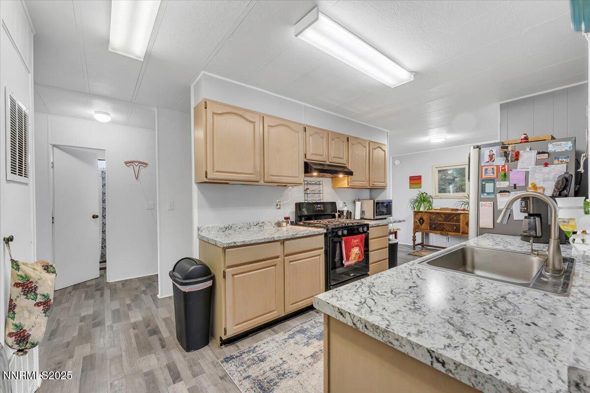 485 Capricorn Circle Reno, NV 89521 - Photo 8 of 31 a kitchen with stainless steel appliances granite countertop a sink stove and refrigerator