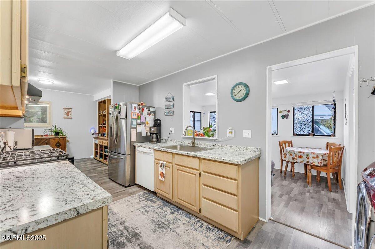 485 Capricorn Circle Reno, NV 89521 - Photo 9 of 31 a kitchen with a sink stove and refrigerator