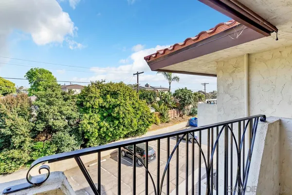 a view of a balcony with flower plants