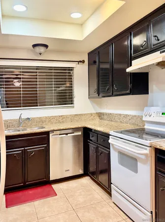 a kitchen with stainless steel appliances granite countertop a stove and a sink