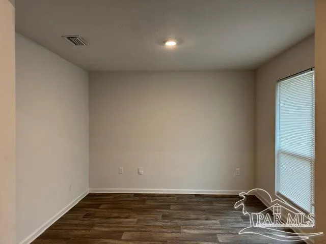 a view of room with wooden floor