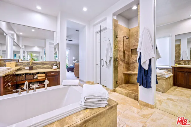 a spacious bathroom with a tub sink and shower