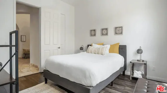 a bedroom with a bed and a night stand