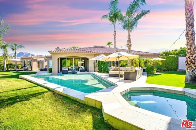 a view of swimming pool with outdoor seating and yard