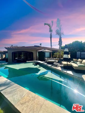 a front view of a house with a garden and patio