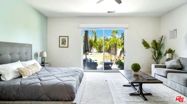 a bedroom with a bed and a couch