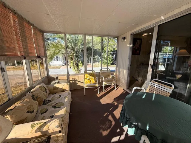 a living room with a couch and a floor to ceiling window