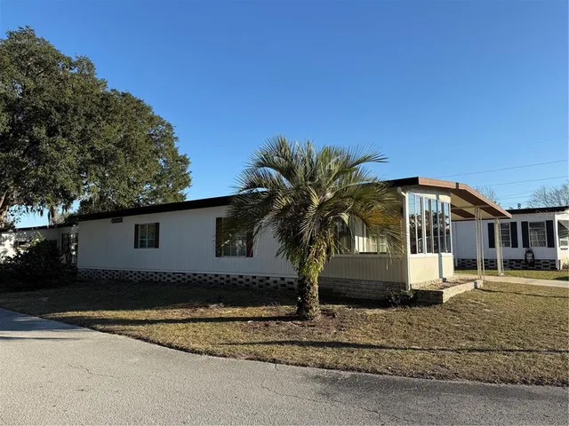 a view of a house with a backyard