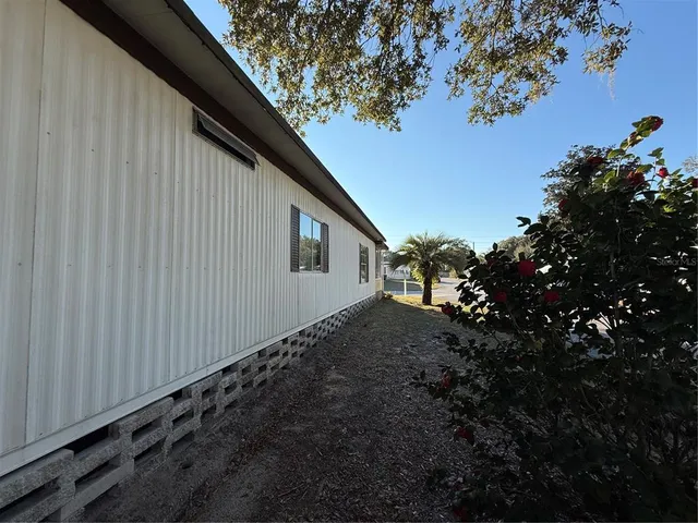 a backyard of a house with lots of plants and trees