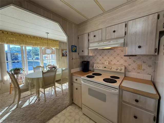 a kitchen with cabinets appliances and furniture