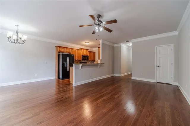 a view of a livingroom with a hardwood floor and a ceiling fan