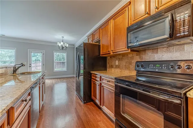 a kitchen with stainless steel appliances granite countertop a stove and a sink