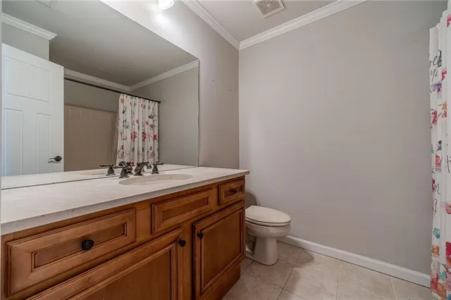 a bathroom with a granite countertop toilet and sink