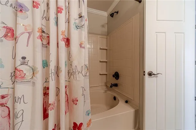 a bathroom with a bathtub and shower