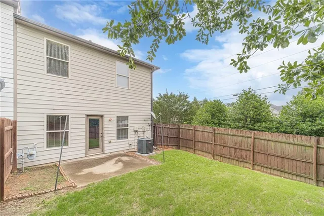 a view of a backyard with a large tree