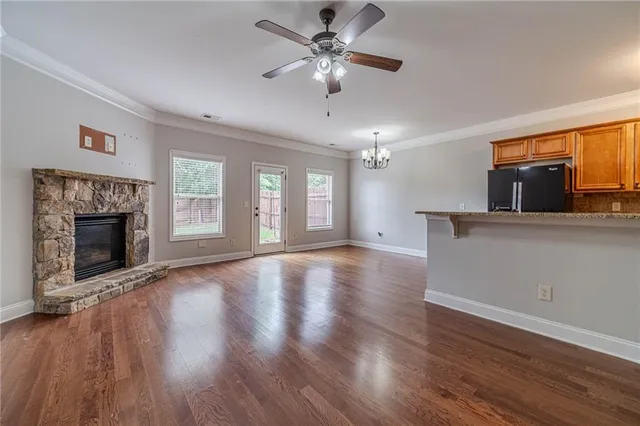 a view of an empty room with a fireplace and a window