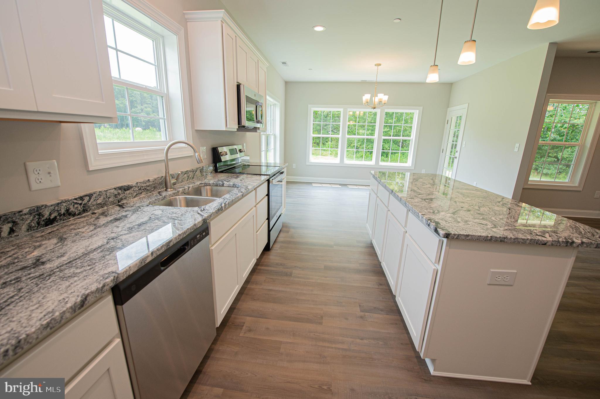 22372 Concord Pond Road Georgetown, DE 19947 - Photo 13 of 43 a kitchen with granite countertop counter space a sink a window and stainless steel appliances