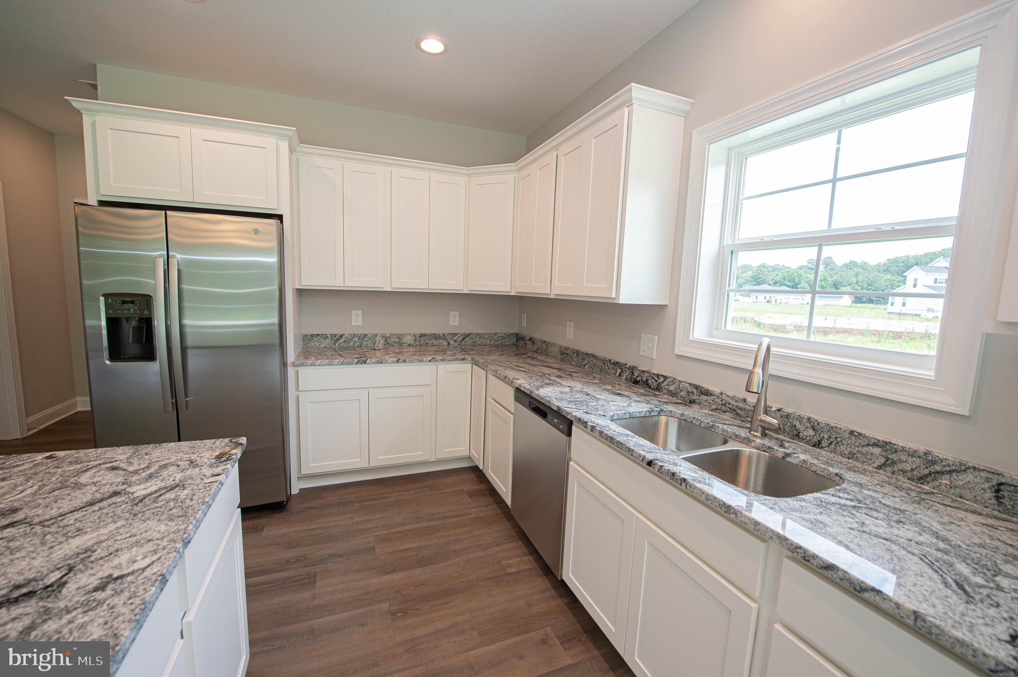 22372 Concord Pond Road Georgetown, DE 19947 - Photo 14 of 43 a kitchen with a sink stove and refrigerator