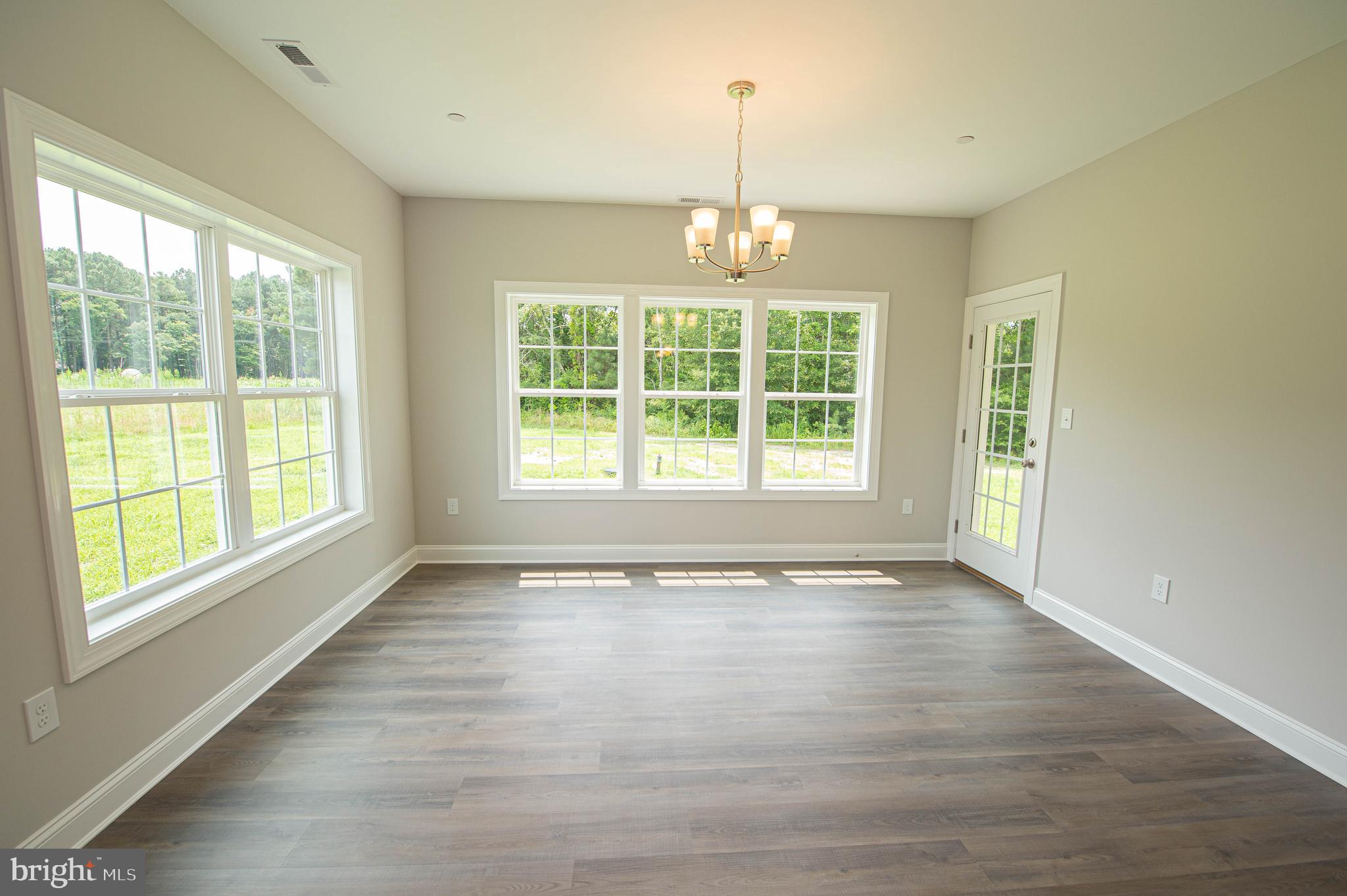 22372 Concord Pond Road Georgetown, DE 19947 - Photo 15 of 43 a view of an empty room with wooden floor and a window