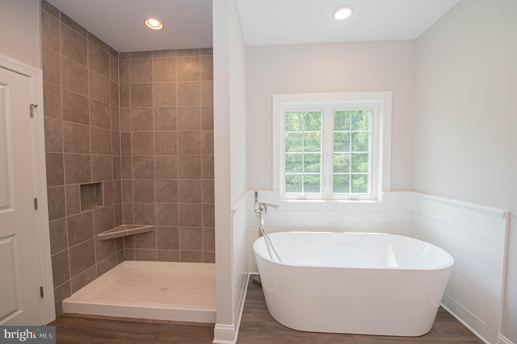 22372 Concord Pond Road Georgetown, DE 19947 - Photo 24 of 43 a white bath tub sitting in a bathroom next to a window