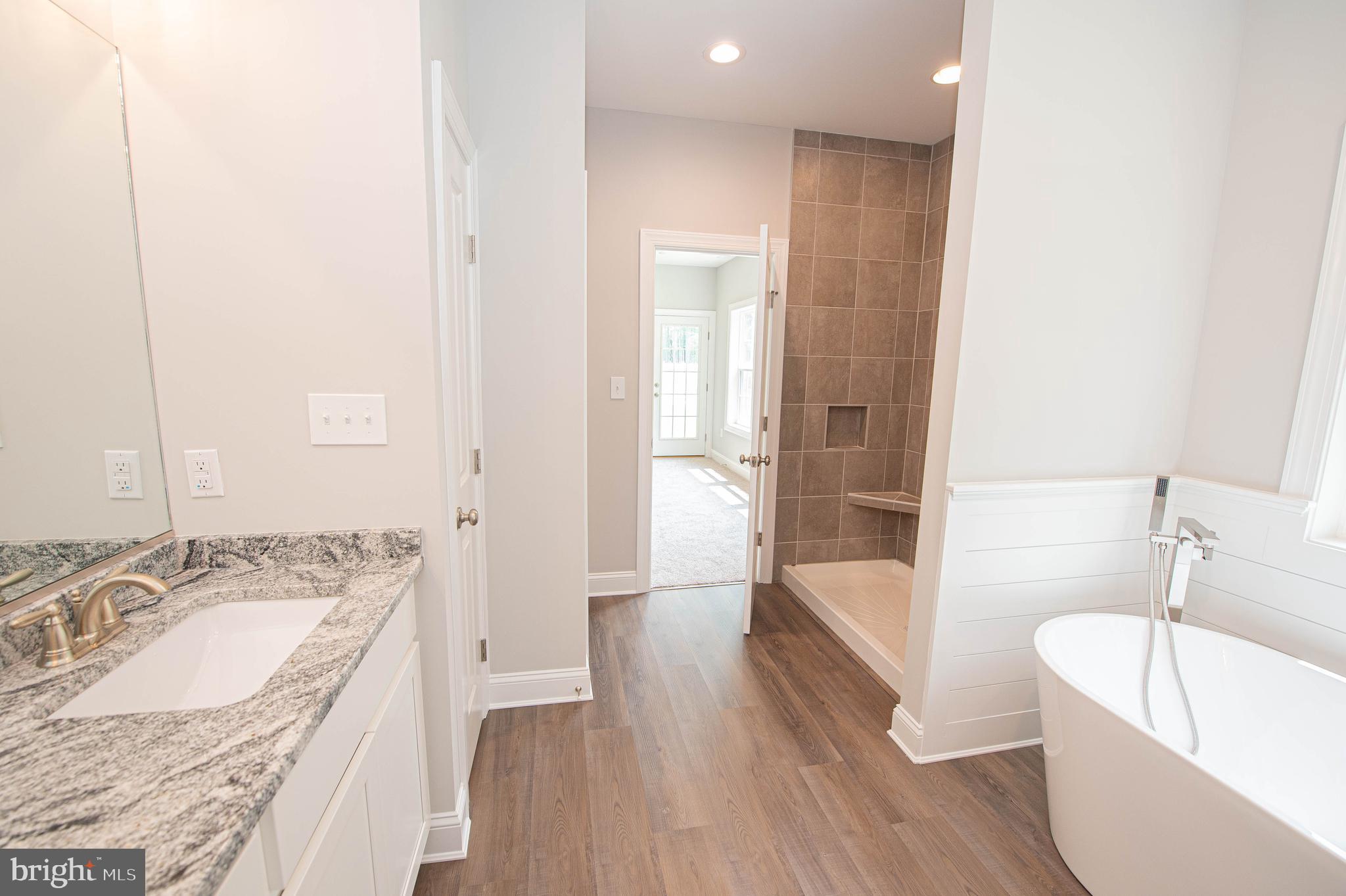 22372 Concord Pond Road Georgetown, DE 19947 - Photo 26 of 43 a bathroom with a granite countertop tub sink and mirror