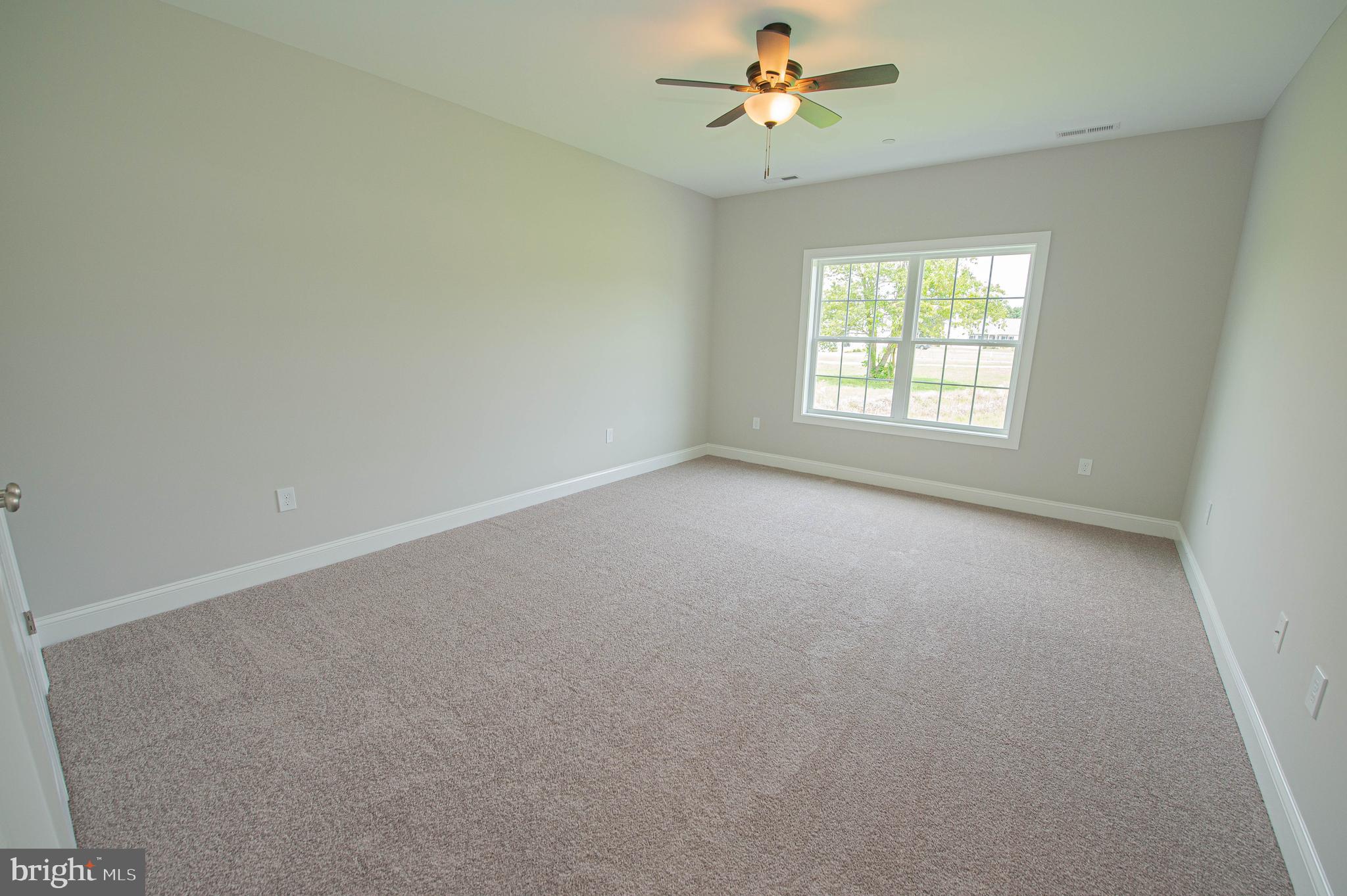 22372 Concord Pond Road Georgetown, DE 19947 - Photo 32 of 43 an empty room with a window and a fan