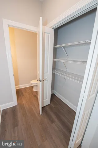 a view of a room with wooden floor