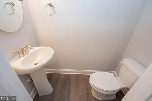 a bathroom with a sink mirror and toilet