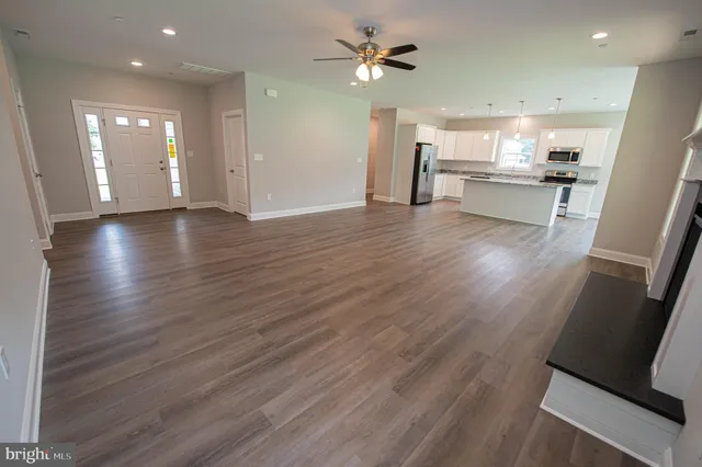 a view of a kitchen with a sink and a refrigerator