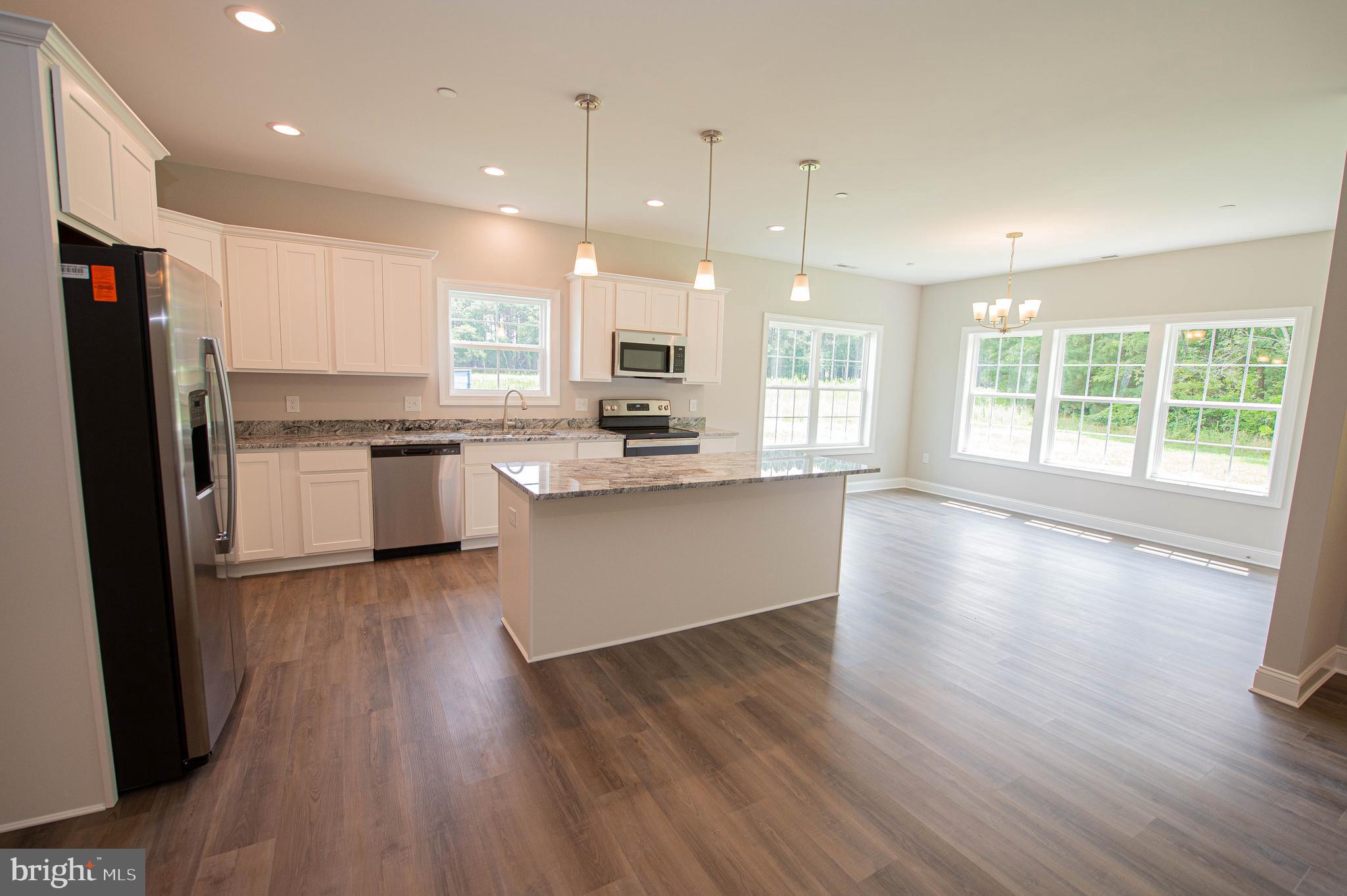 22372 Concord Pond Road Georgetown, DE 19947 - Photo 8 of 43 a large kitchen with stainless steel appliances granite countertop a stove a sink a refrigerator and a large window