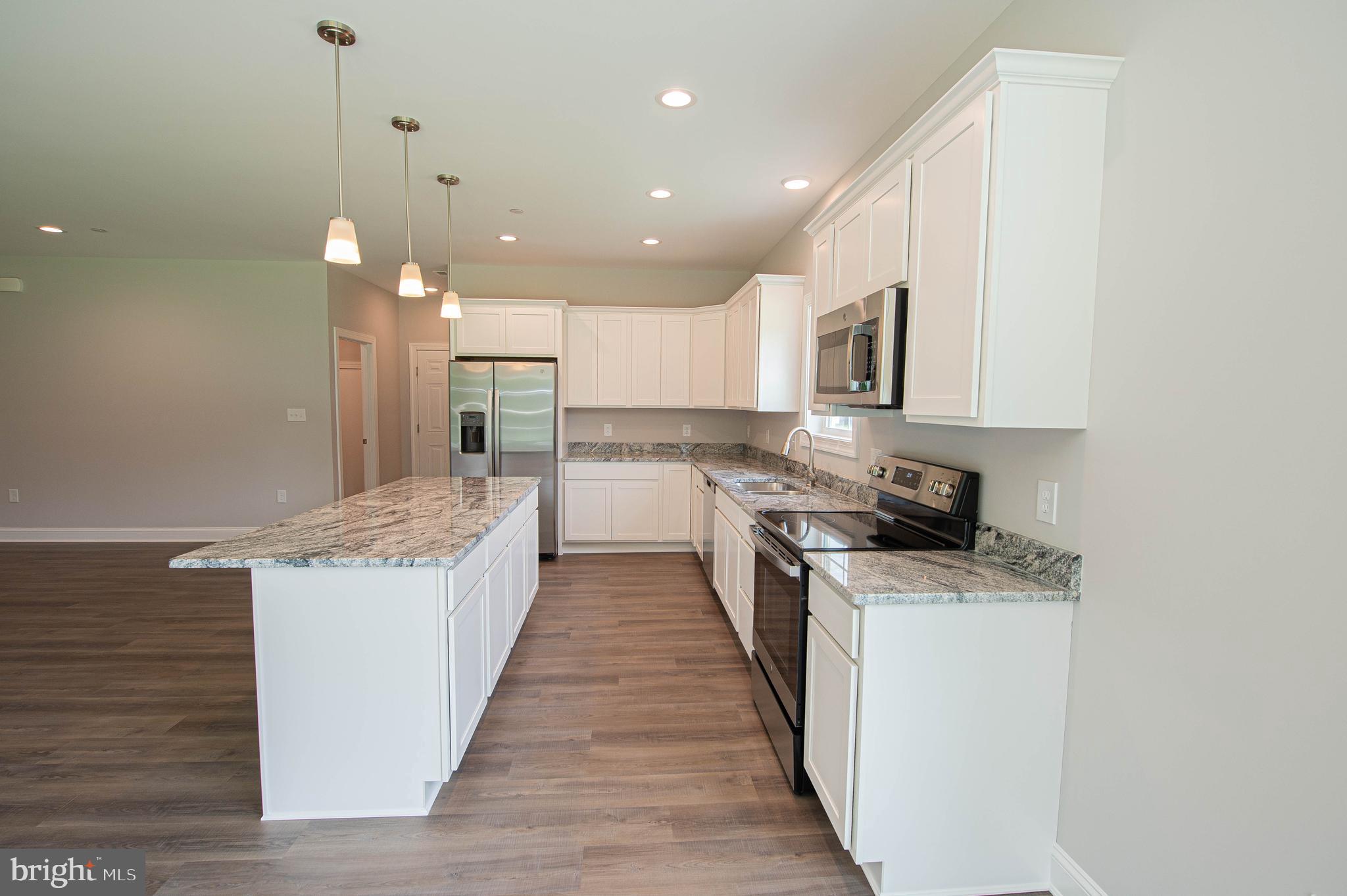 22372 Concord Pond Road Georgetown, DE 19947 - Photo 10 of 43 a kitchen with stainless steel appliances granite countertop a stove a sink and a refrigerator
