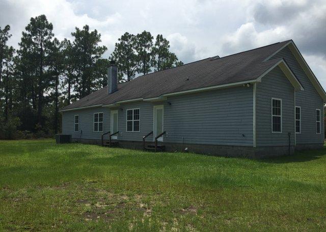 35 Sexton Road DeFuniak Springs, FL 32433 - Photo 14 of 14 a front view of a house with a garden