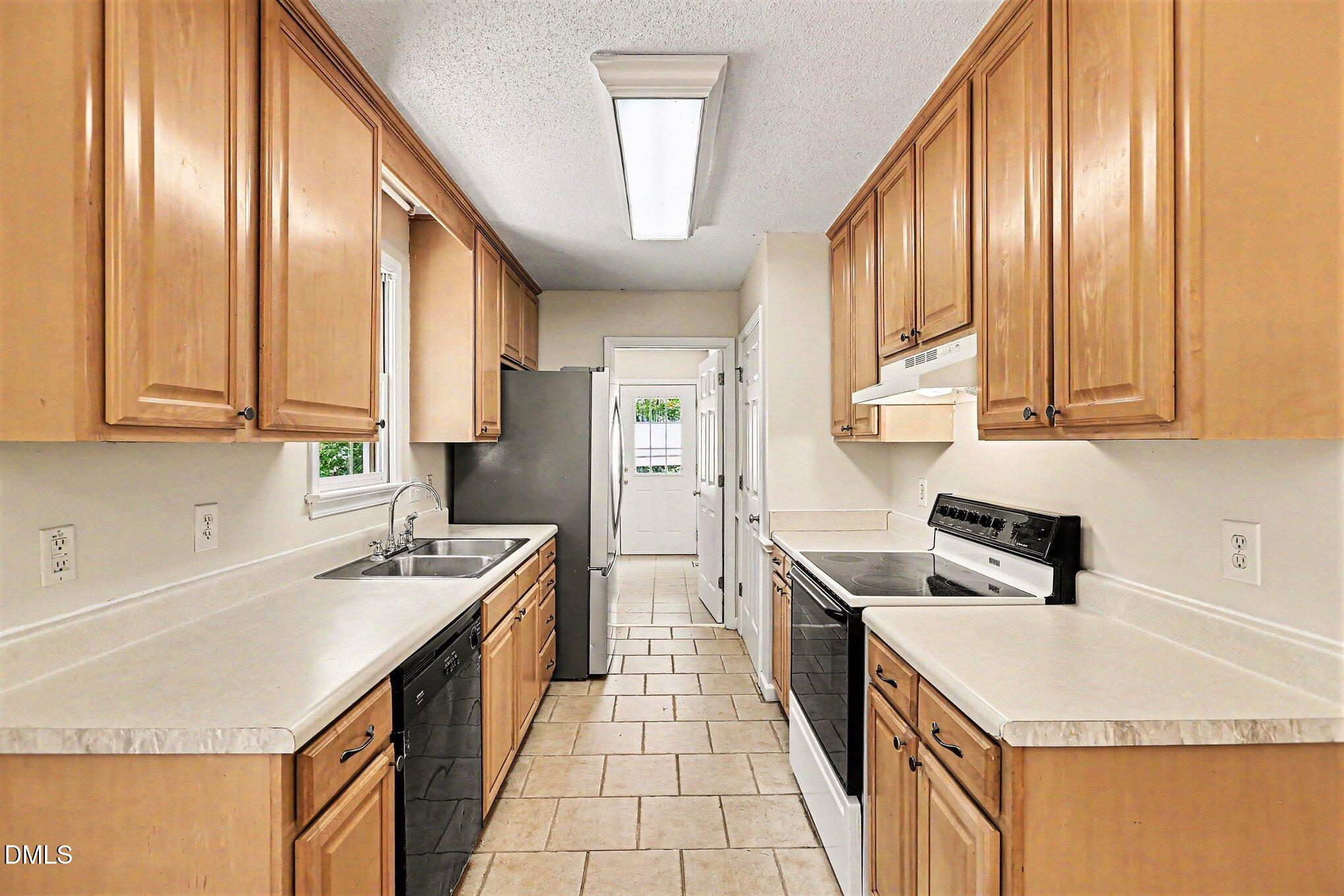 5359 Bass Mountain Road Snow Camp, NC 27349 - Photo 5 of 25 a kitchen with a sink a stove and cabinets