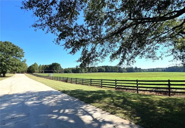 a view of a room with wooden floor fireplace and windows