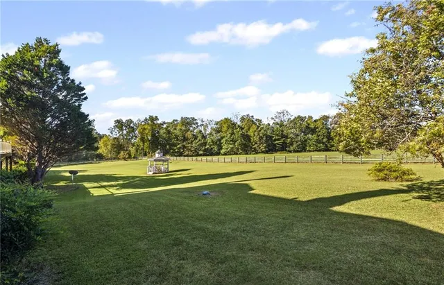 an aerial view of a house with garden space and a lake view