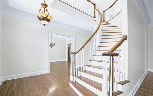 a large kitchen with granite countertop a stove top oven a sink a counter space and stainless steel appliances