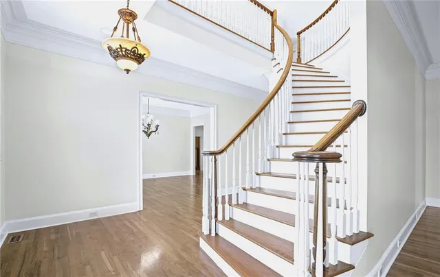 a living room with stainless steel appliances furniture and a kitchen view