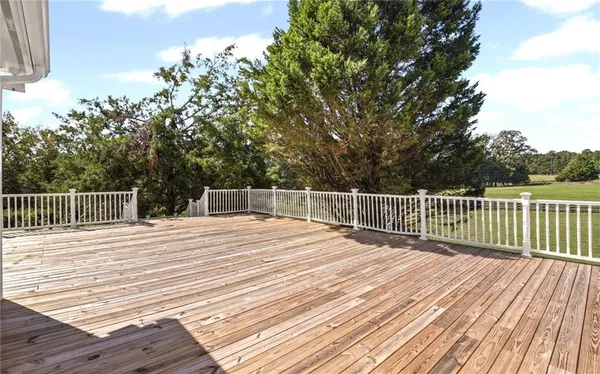 an aerial view of a house with garden space and a lake view