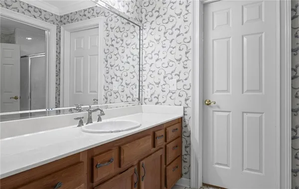a bathroom with a granite countertop toilet and a sink