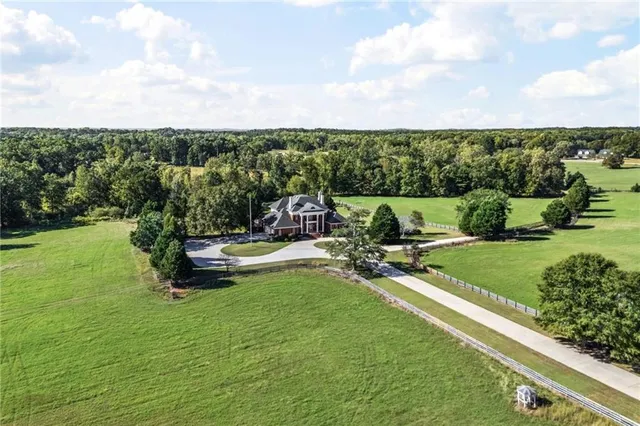 a kitchen with stainless steel appliances granite countertop a refrigerator a stove and a wooden cabinets