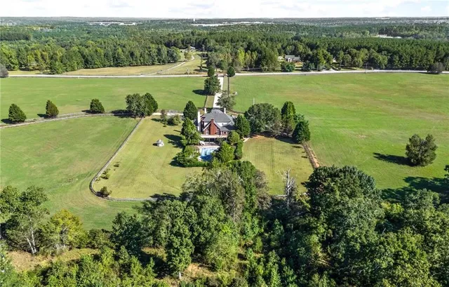 a large kitchen with granite countertop a stove top oven a sink a counter space and stainless steel appliances