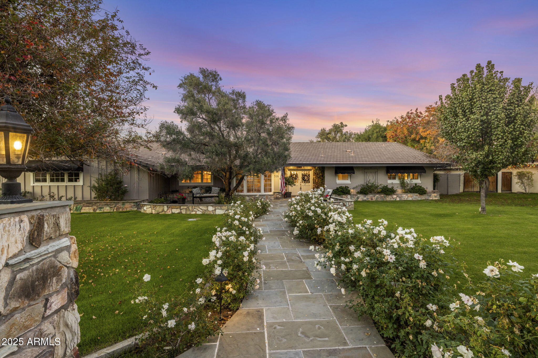 a front view of a house with a garden