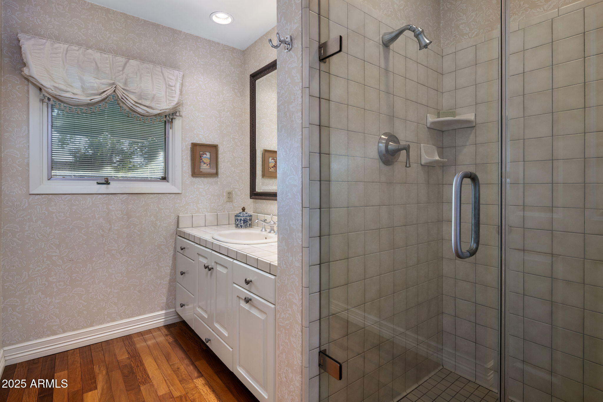 516 West Lawrence Road Phoenix, AZ 85013 - Photo 35 of 65 a bathroom with a sink a large mirror and shower