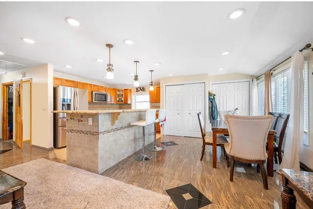 a dining room with furniture and wooden floor
