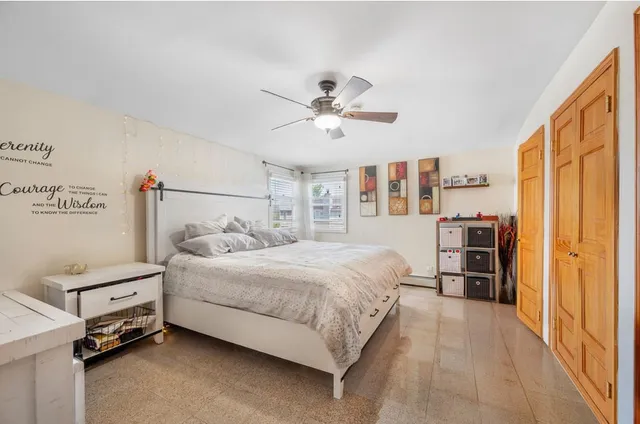 a bed room with a bed and a chair