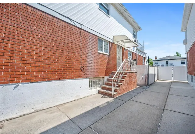 a view of a house with stairs and a floor to ceiling window