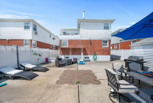 a view of a patio with a table and chairs