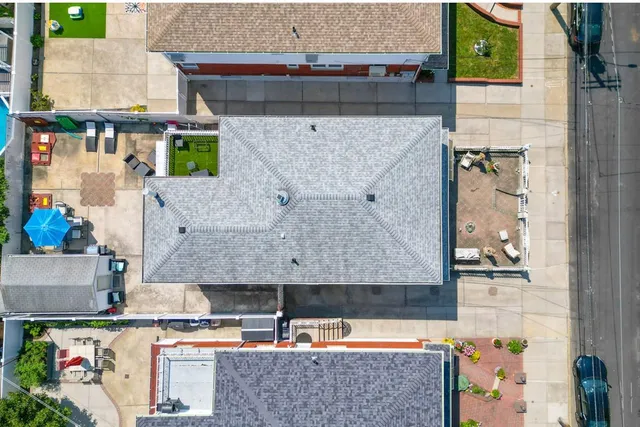 an aerial view of a house with a swimming pool