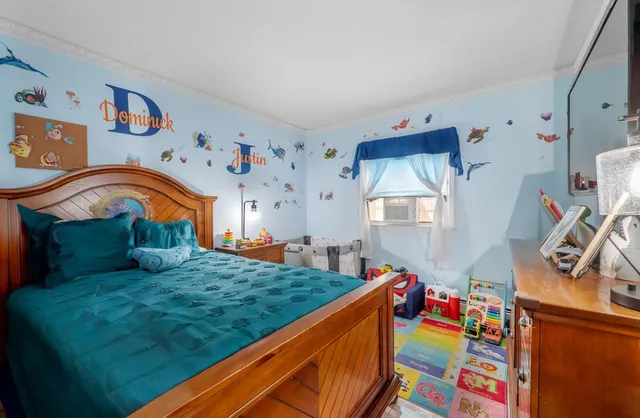 a bed room with furniture and a baby crib